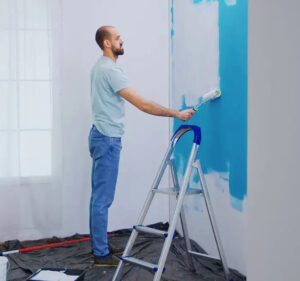 Skilled painters completing interior wall painting with a smooth finish